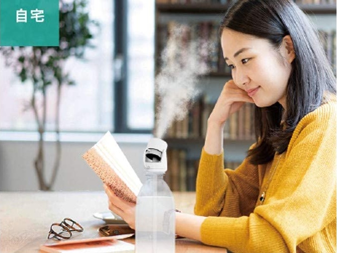 USBのペットボトル加湿器を使っている女性